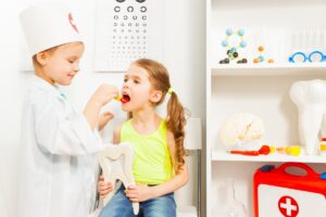 young kids playing dentist